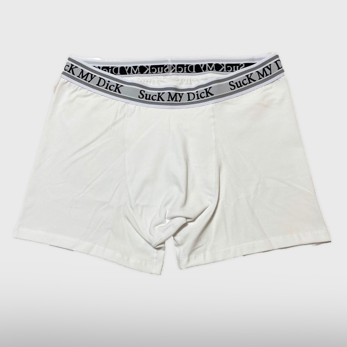 White boxer briefs with a black waistband featuring text on a white background