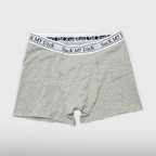 Heather grey Suck My Dick boxer briefs laid flat, front view with a white and grey waistband