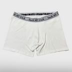 White Suck My Dick boxer briefs laid flat, front view with a white and grey waistband