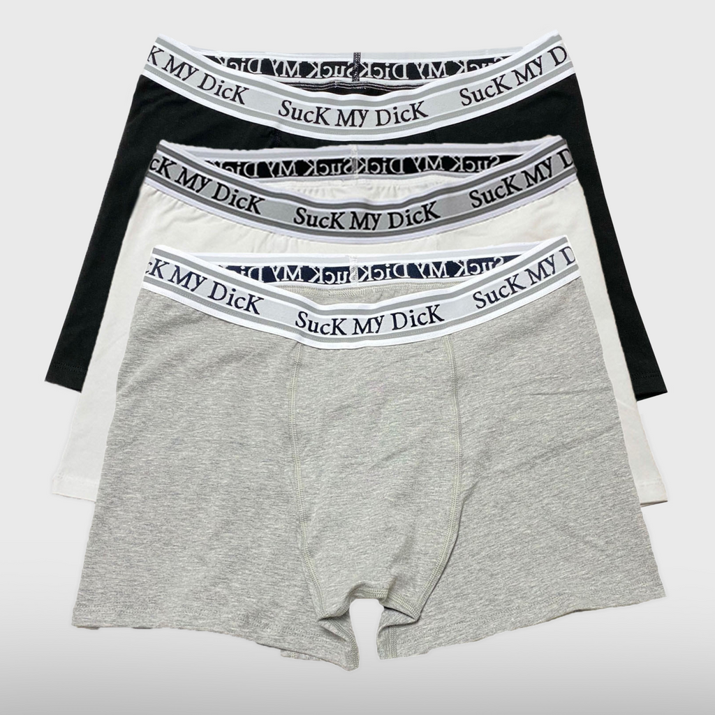 Three Suck My Dick boxer briefs in black, white and heather grey, stacked to show each waistband
